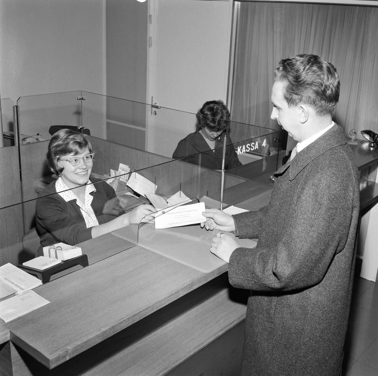 Customer paying with their phone at a small shop counter